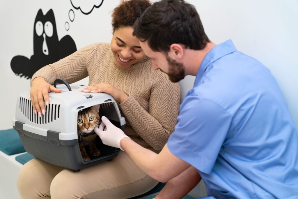 Pet owner with a cat carrier during a vet exam